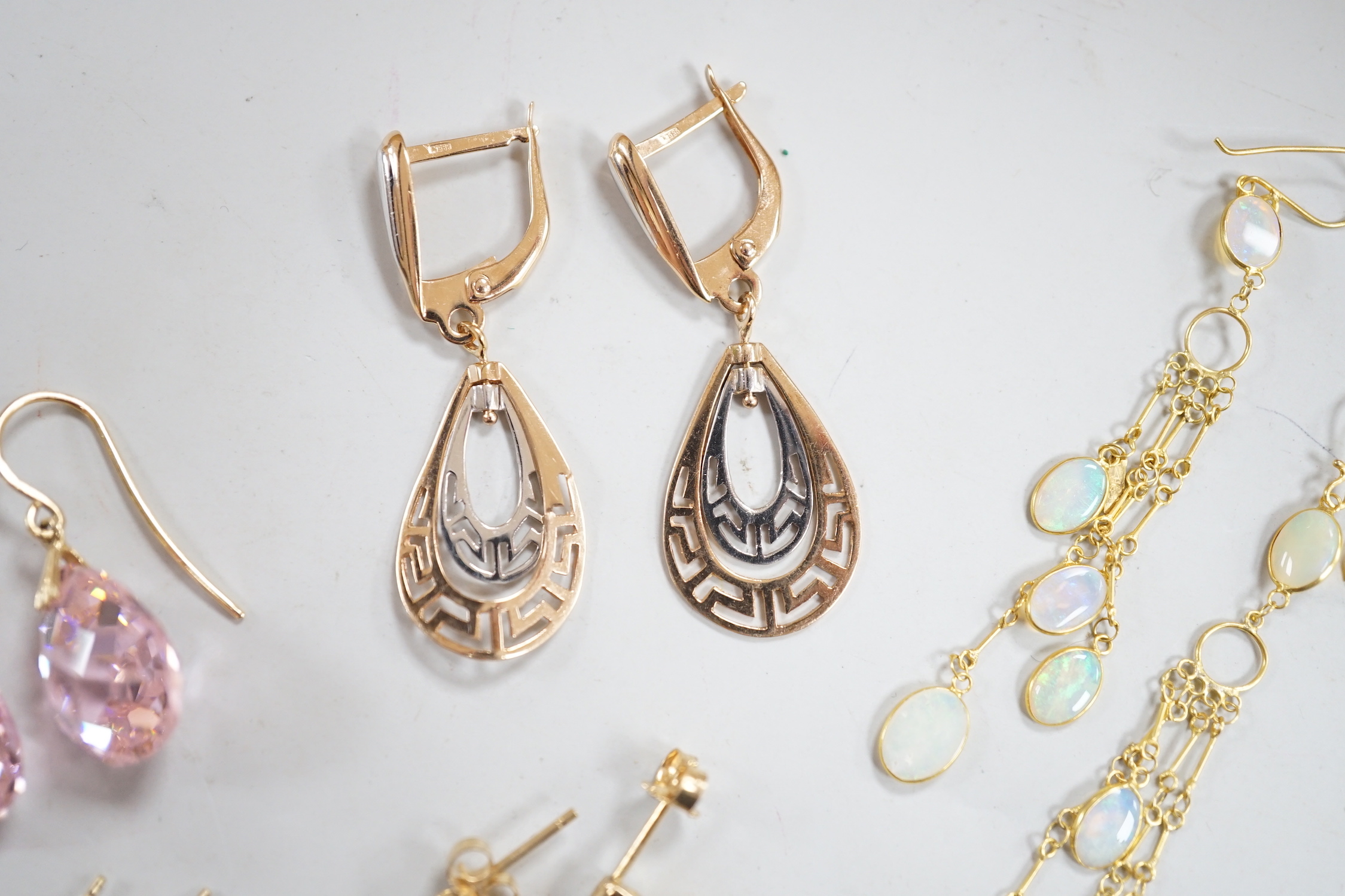 Two modern pairs of 14k drop earrings including pink cubic zirconia, 15mm, gross weight 10.1 grams, two similar pairs of 10k and gem set earrings, gross weight 2.7 grams and a modern pair of yellow metal and opal cluster